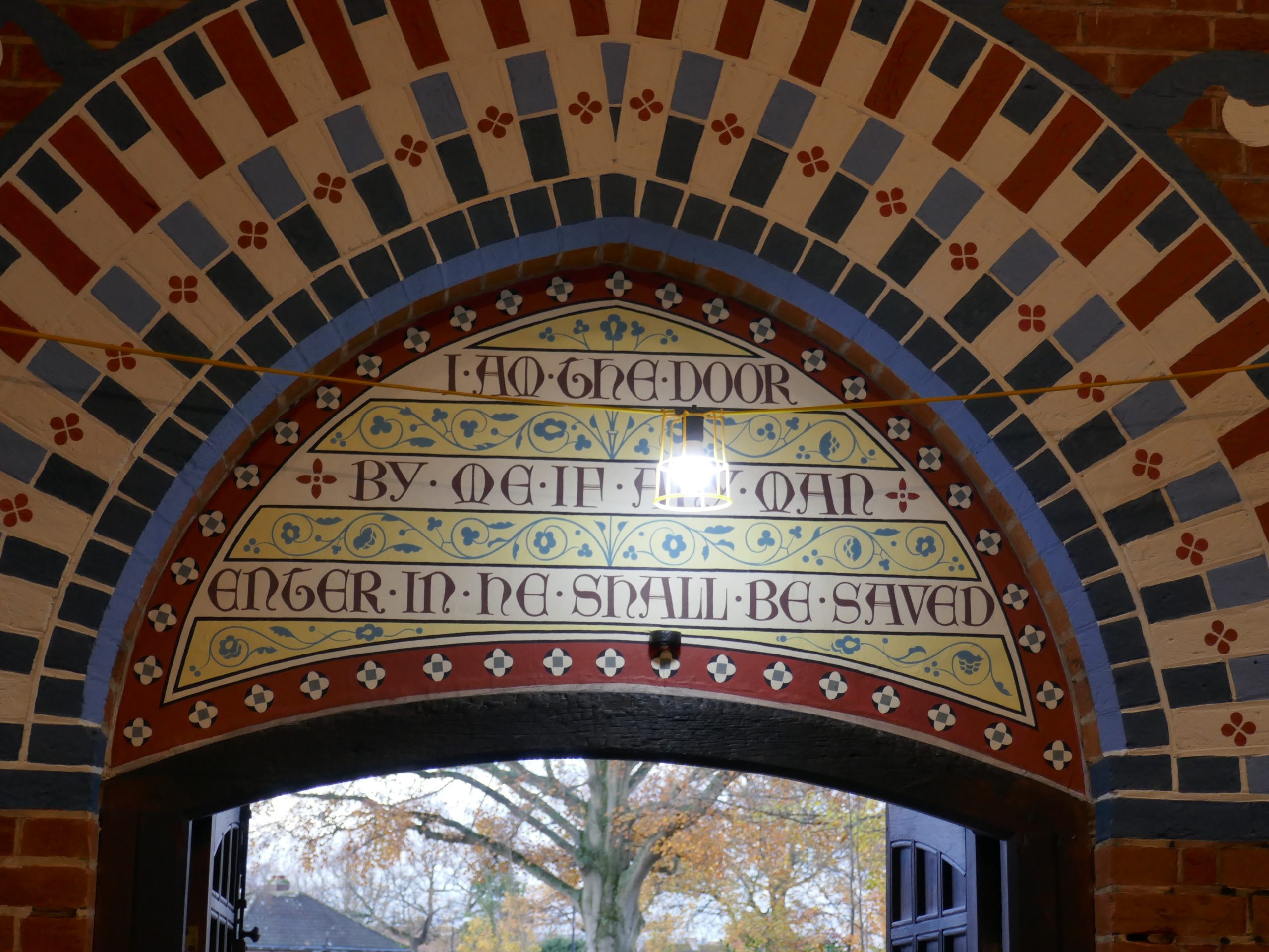 Image of writing above on of the doorways inside All Saints Church
